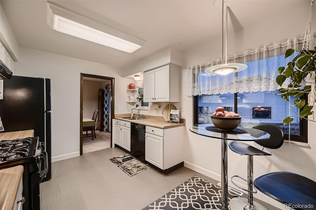 kitchen featuring baseboards, open shelves, white cabinetry, and black appliances