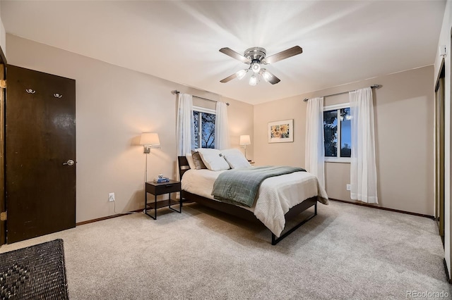 carpeted bedroom with baseboards and a ceiling fan