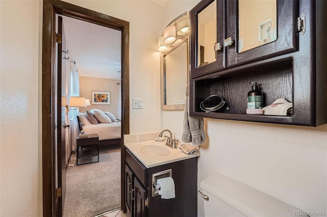 bathroom with toilet, ensuite bath, and vanity