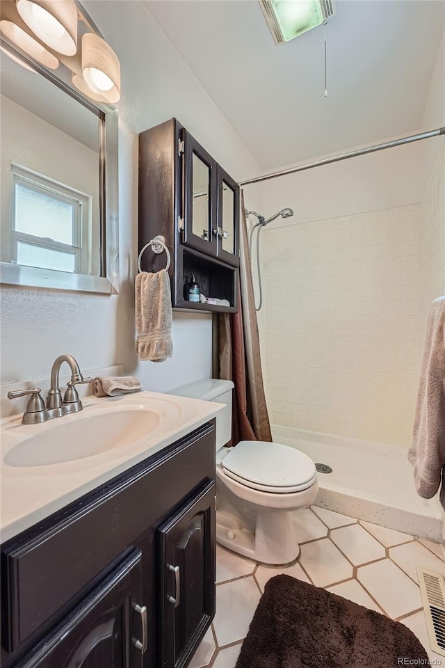 bathroom featuring visible vents, a stall shower, toilet, and vanity