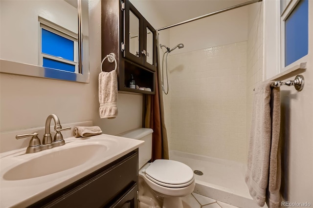 full bath featuring vanity, a stall shower, and toilet