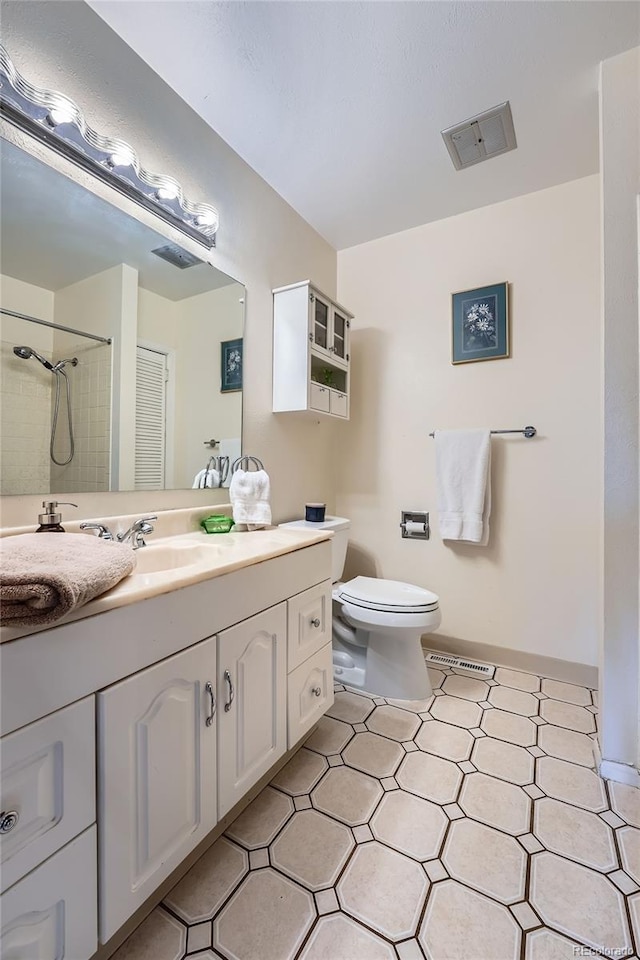 full bathroom with vanity, toilet, tile patterned floors, visible vents, and tiled shower