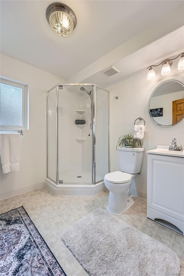 bathroom featuring vanity, toilet, tile patterned floors, visible vents, and a stall shower