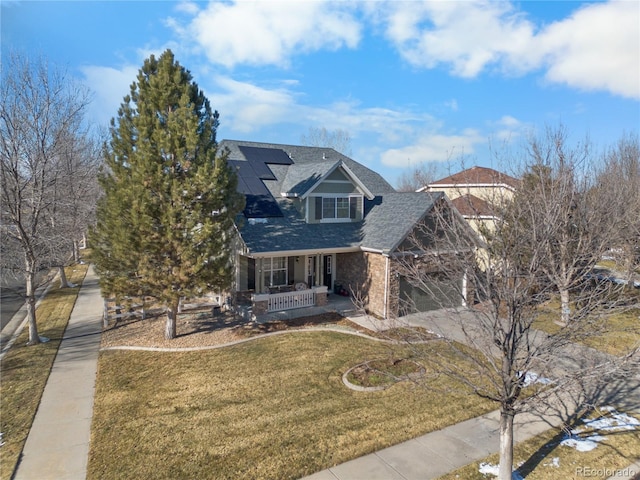 view of front facade featuring a front yard, a porch, and a garage