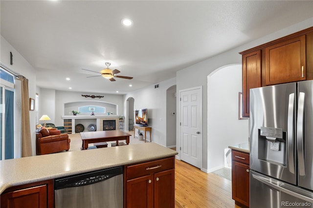 kitchen with light hardwood / wood-style floors, appliances with stainless steel finishes, and ceiling fan