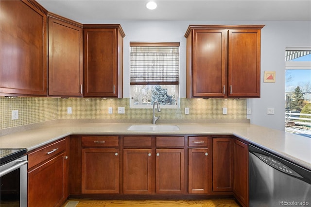 kitchen with sink, decorative backsplash, and appliances with stainless steel finishes