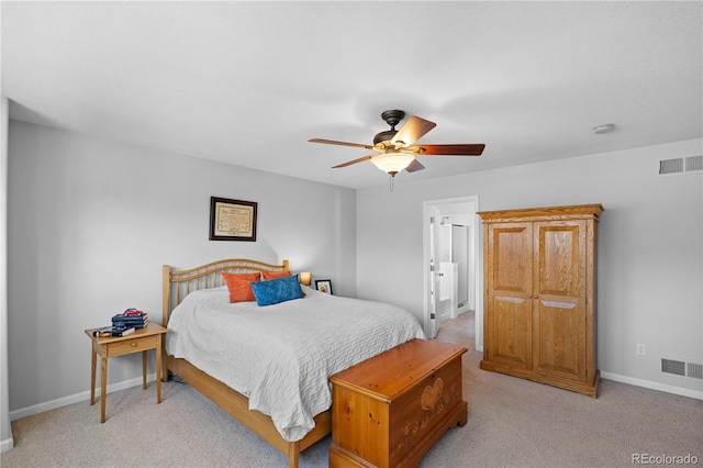 bedroom featuring light carpet, connected bathroom, and ceiling fan