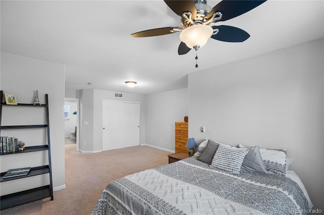 bedroom with ceiling fan, carpet, and a closet