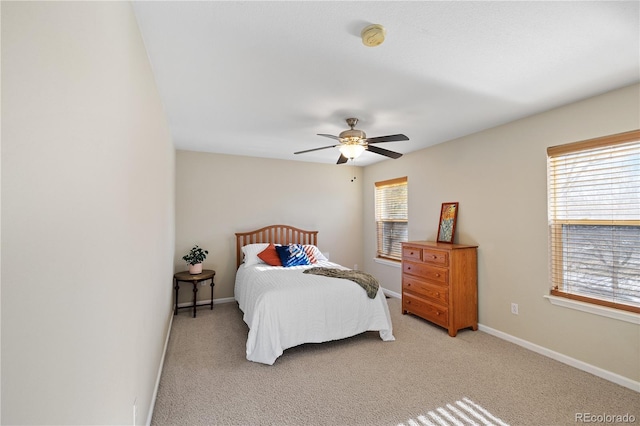 bedroom with ceiling fan and light carpet