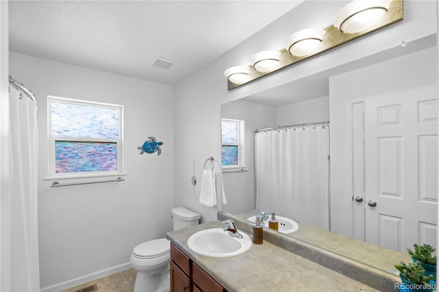 bathroom with tile patterned floors, toilet, and vanity