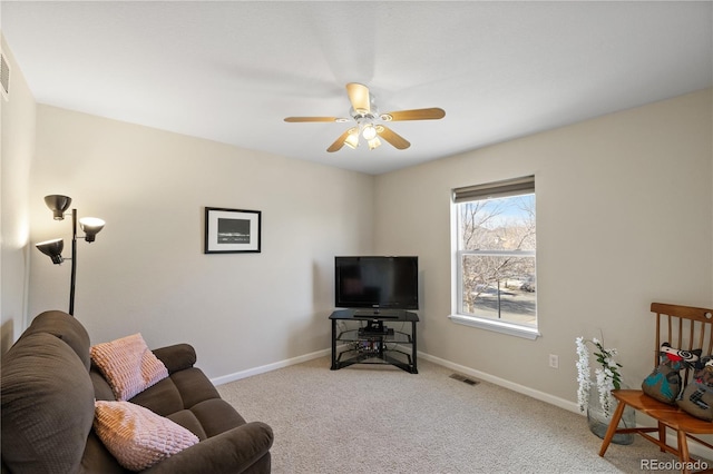 carpeted living room with ceiling fan