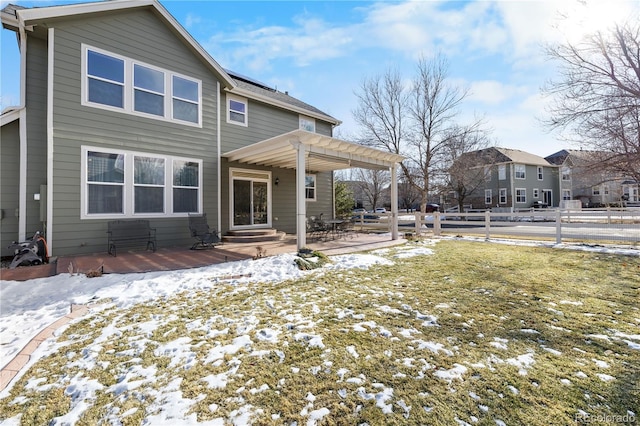 snow covered property featuring a yard, a patio, and a pergola