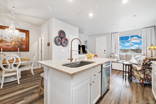 kitchen with open floor plan, dark wood-type flooring, white cabinetry, a sink, and dishwasher