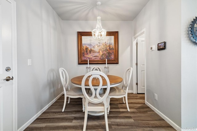 dining room with an inviting chandelier, dark wood finished floors, and baseboards