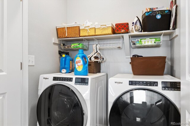 washroom with washing machine and clothes dryer