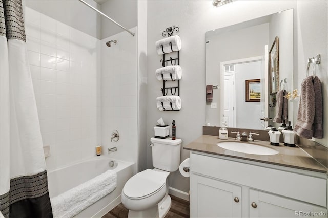 full bathroom featuring vanity, wood finished floors, shower / bath combination with curtain, toilet, and baseboards