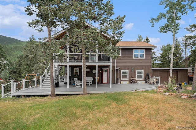 9075 Jill Dr, Conifer, CO 80433 - rear view of house featuring a deck, a yard, a storage shed, and stairway