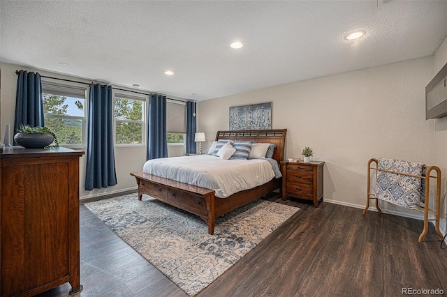 9075 Jill Dr, Conifer, CO 80433 - bedroom with dark wood finished floors, a textured ceiling, recessed lighting, and a textured wall