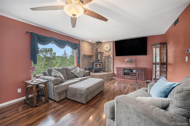 9075 Jill Dr, Conifer, CO 80433 - living room with a wood stove, wood finished floors, and ceiling fan