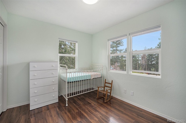 9075 Jill Dr, Conifer, CO 80433 - bedroom featuring wood finished floors and a nursery area