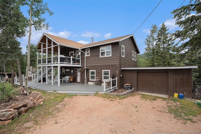 9075 Jill Dr, Conifer, CO 80433 - rear view of property featuring dirt driveway, a wooden deck, and stairs