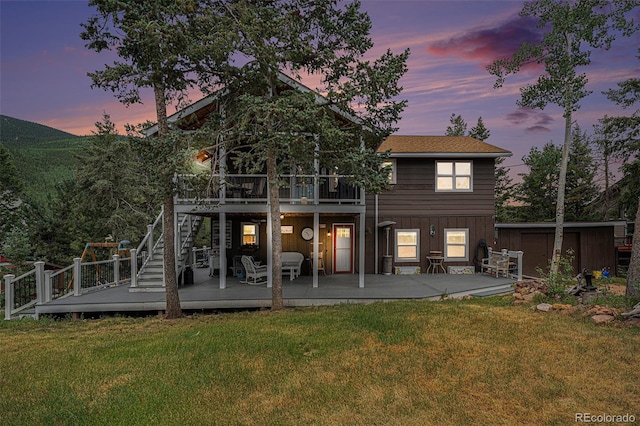 9075 Jill Dr, Conifer, CO 80433 - back of property featuring a deck, a yard, stairway, and a storage shed