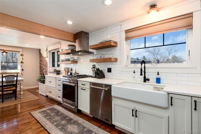 6361 S Spotswood Cir, Littleton, CO 80120 - kitchen featuring island exhaust hood, appliances with stainless steel finishes, backsplash, healthy amount of natural light, and recessed lighting
