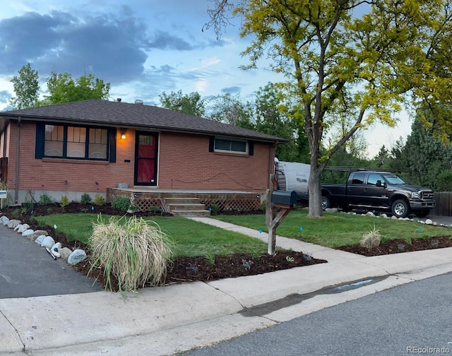 6361 S Spotswood Cir, Littleton, CO 80120 - ranch-style house featuring brick siding, a front lawn, and a shingled roof