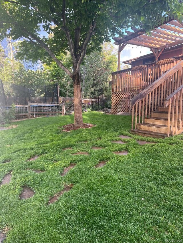 6361 S Spotswood Cir, Littleton, CO 80120 - view of yard featuring a trampoline, a pergola, stairs, and a deck