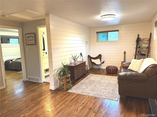 6361 S Spotswood Cir, Littleton, CO 80120 - sitting room with dark wood-style flooring, a textured ceiling, and wooden walls