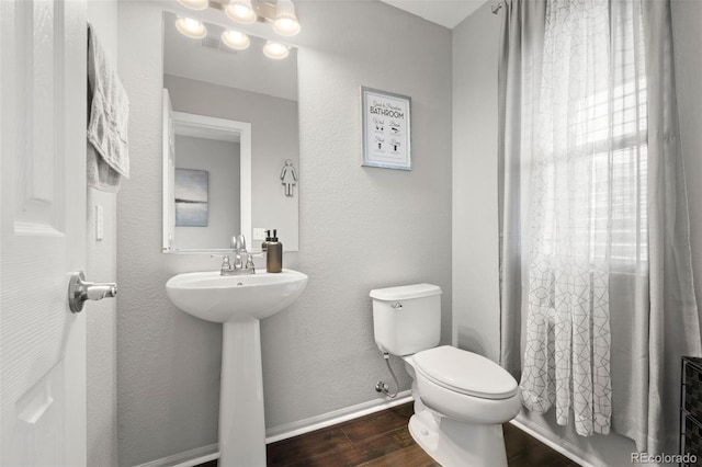 bathroom featuring sink, toilet, and hardwood / wood-style floors
