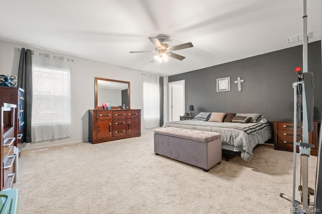 bedroom featuring ceiling fan and carpet