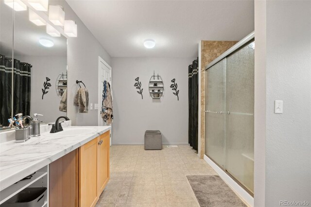 bathroom featuring vanity and an enclosed shower