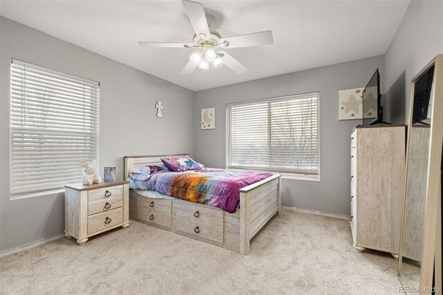 bedroom featuring light carpet and ceiling fan