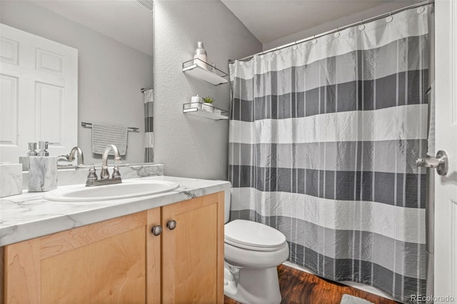 bathroom featuring hardwood / wood-style flooring, vanity, and toilet