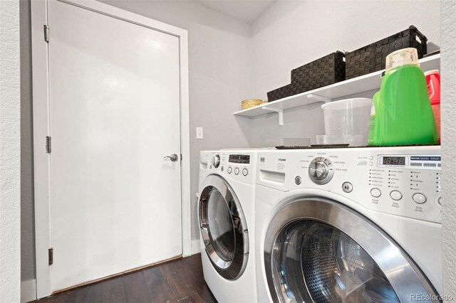 laundry area with dark hardwood / wood-style floors and washer and clothes dryer
