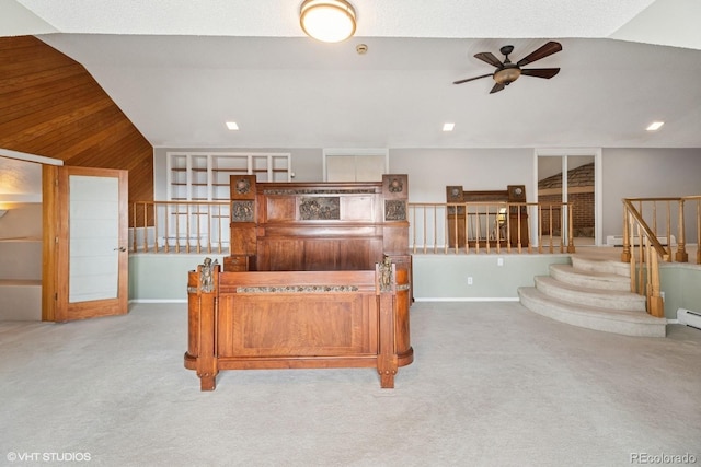 22081 Paradise Cir, Golden, CO 80401 - living area featuring carpet flooring, a ceiling fan, vaulted ceiling, baseboard heating, and wood walls