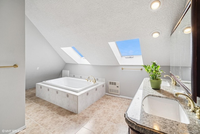22081 Paradise Cir, Golden, CO 80401 - bathroom featuring a skylight, vaulted ceiling, a textured ceiling, a bath, and tile patterned floors