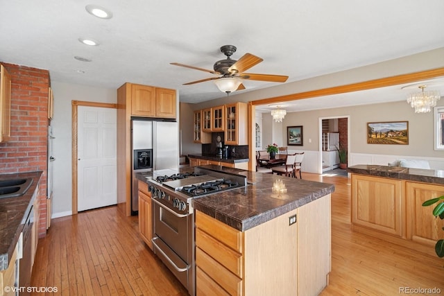 22081 Paradise Cir, Golden, CO 80401 - kitchen with appliances with stainless steel finishes, a chandelier, light wood-type flooring, glass insert cabinets, and recessed lighting