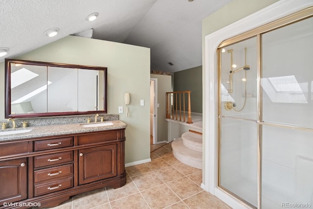 22081 Paradise Cir, Golden, CO 80401 - bathroom featuring a shower stall, lofted ceiling, tile patterned floors, double vanity, and baseboards