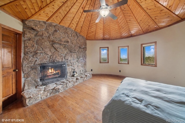 22081 Paradise Cir, Golden, CO 80401 - bedroom featuring wooden ceiling, wood finished floors, a stone fireplace, baseboards, and high vaulted ceiling