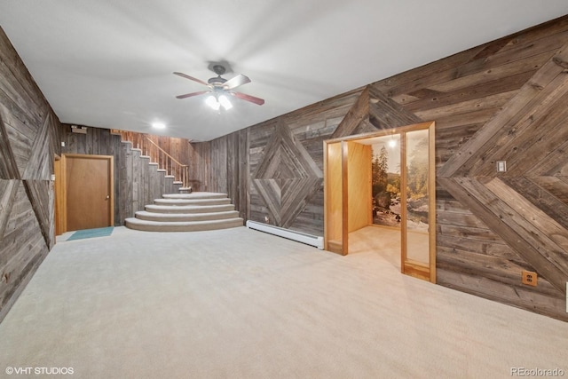 22081 Paradise Cir, Golden, CO 80401 - basement with wooden walls, a baseboard radiator, a ceiling fan, stairs, and carpet flooring