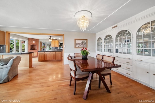 22081 Paradise Cir, Golden, CO 80401 - dining space with light wood-style flooring, a chandelier, and a ceiling fan