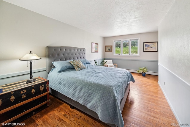 22081 Paradise Cir, Golden, CO 80401 - bedroom featuring wood finished floors, a textured ceiling, and baseboards