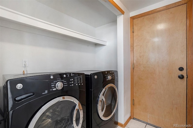 laundry room with light tile patterned flooring and washing machine and clothes dryer