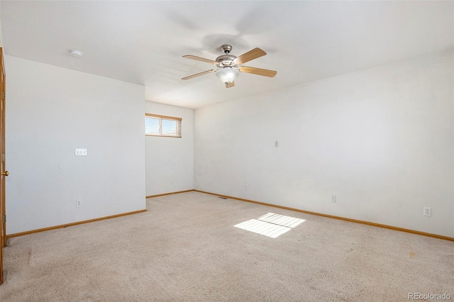 unfurnished room with ceiling fan and light colored carpet