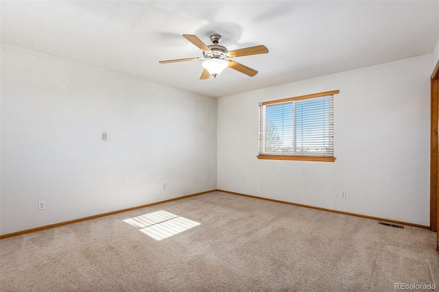 empty room featuring light carpet and ceiling fan