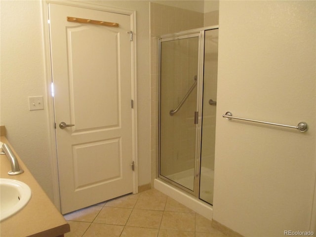 bathroom featuring an enclosed shower, vanity, and tile patterned floors