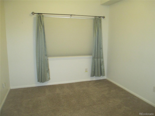 unfurnished room featuring light carpet