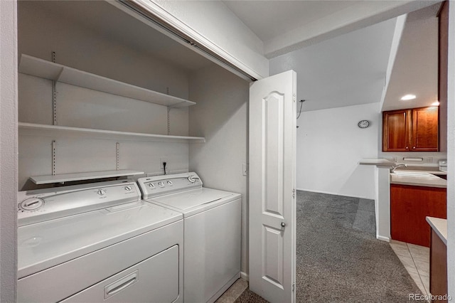 laundry area featuring light colored carpet, separate washer and dryer, and sink